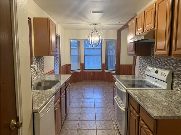 a kitchen with a sink and a refrigerator