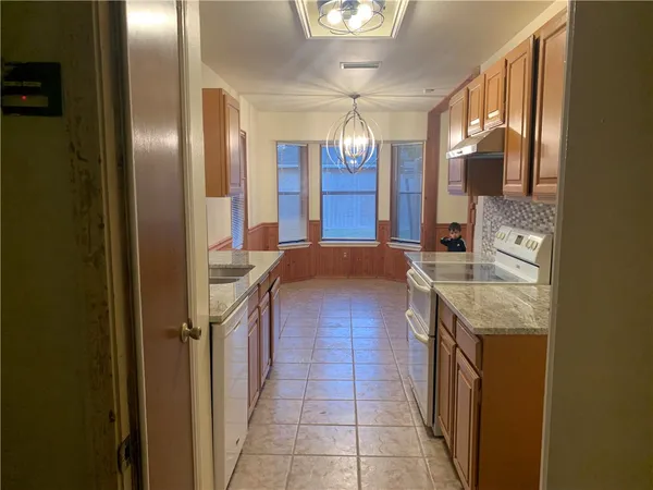 a kitchen with stainless steel appliances granite countertop a sink and cabinets
