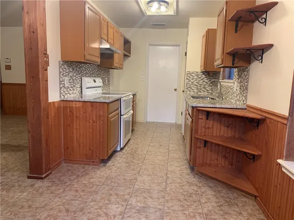 a kitchen with stainless steel appliances granite countertop a stove and a sink