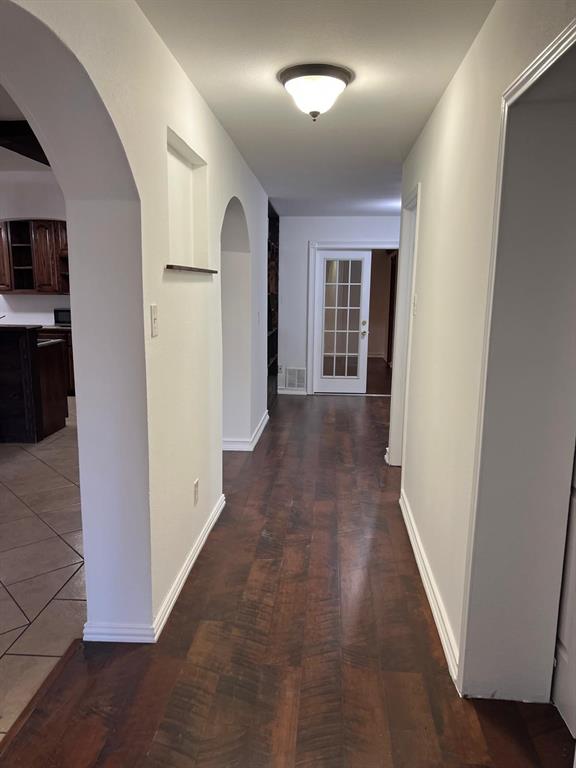 6707 Elam Road Dallas, TX 75217 - Photo 6 of 18 a view of a hallway with wooden floor and closet
