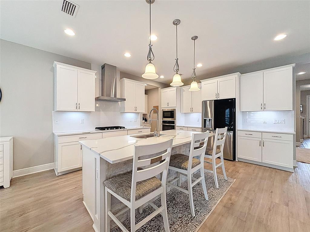 4312 Burdick Loop Odessa, FL 33556 - Photo 11 of 55 a kitchen with a white cabinets and stainless steel appliances