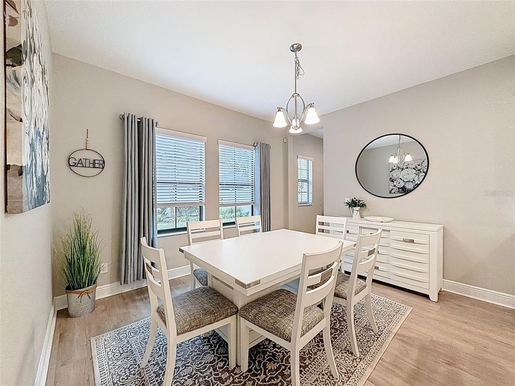 4312 Burdick Loop Odessa, FL 33556 - Photo 17 of 55 a view of a dining room with furniture and chandelier