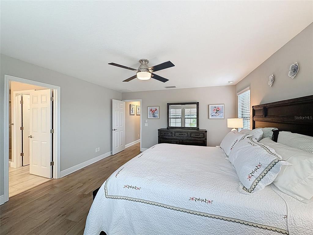 4312 Burdick Loop Odessa, FL 33556 - Photo 26 of 55 a bed room with a bed a window and a television