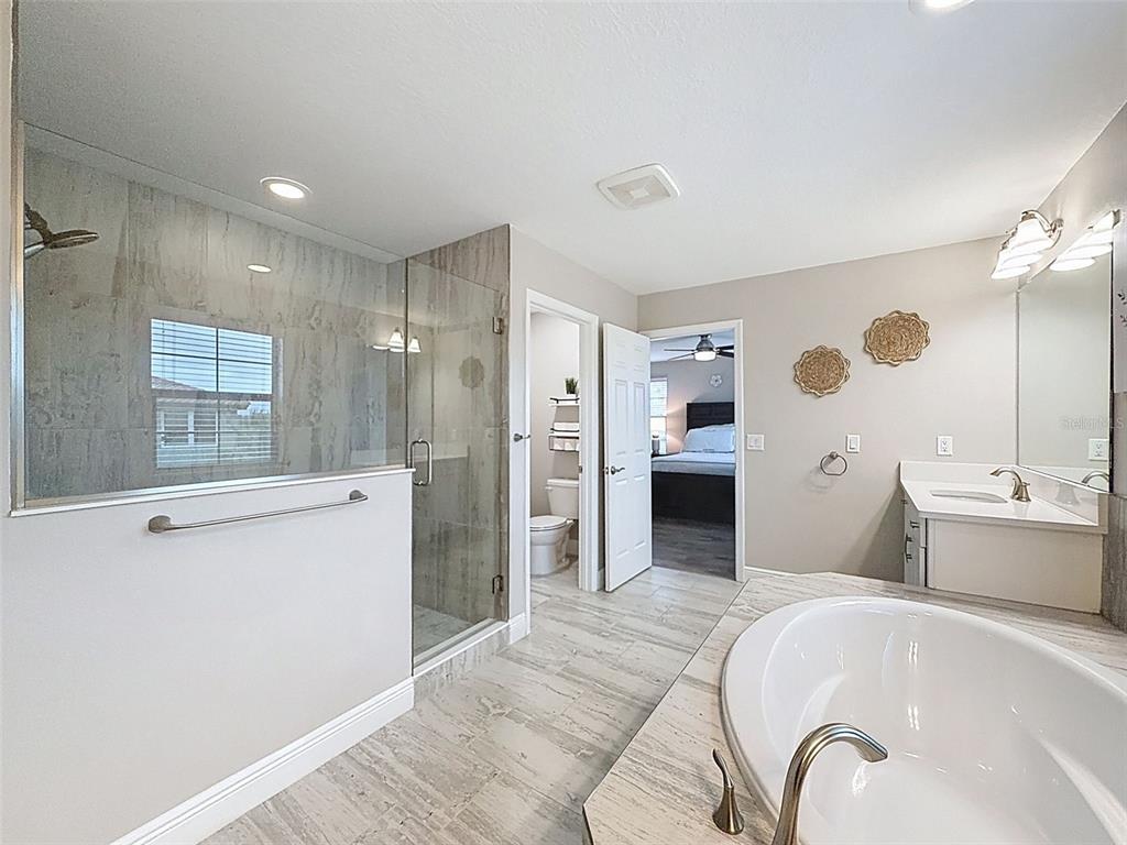 4312 Burdick Loop Odessa, FL 33556 - Photo 28 of 55 a spacious bathroom with a tub sink and shower