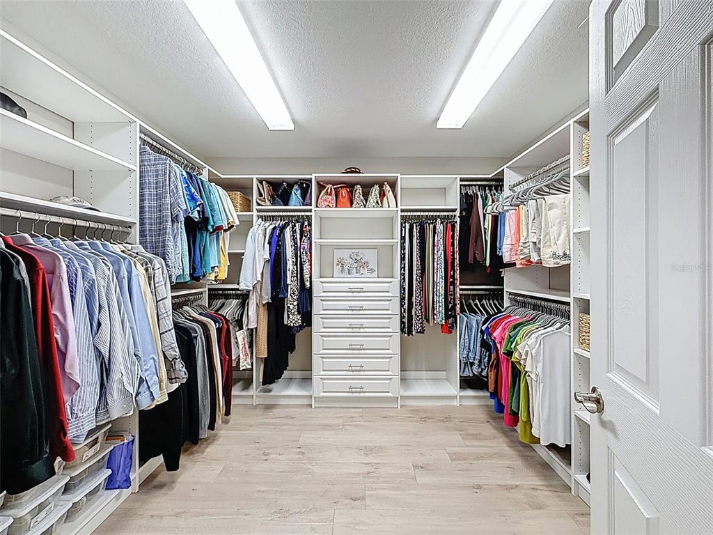 4312 Burdick Loop Odessa, FL 33556 - Photo 29 of 55 a view of walk in closet with clothes and shoes