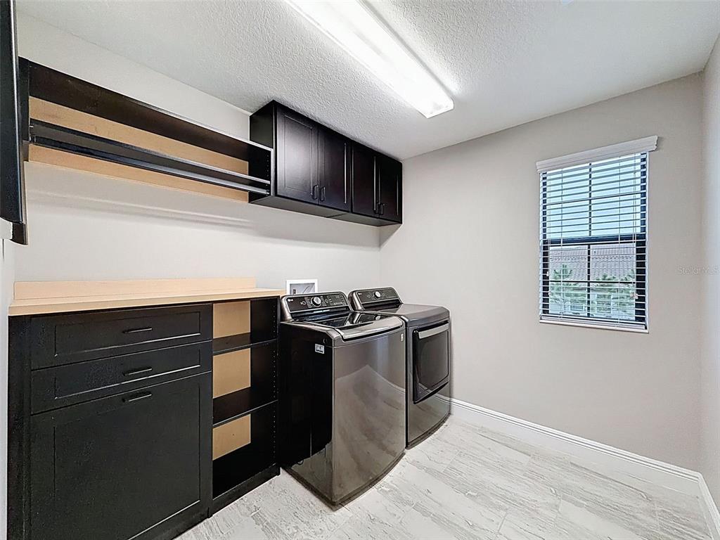 4312 Burdick Loop Odessa, FL 33556 - Photo 35 of 55 a kitchen with stainless steel appliances granite countertop a stove and a microwave