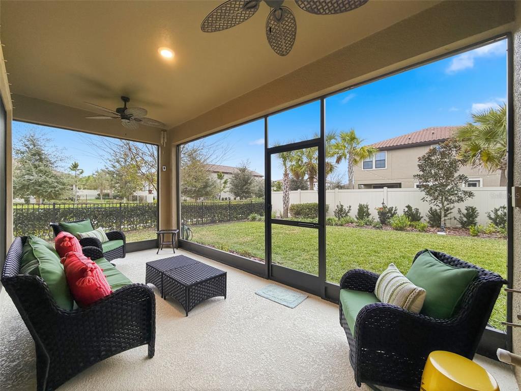 4312 Burdick Loop Odessa, FL 33556 - Photo 36 of 55 a living room with furniture and a floor to ceiling window