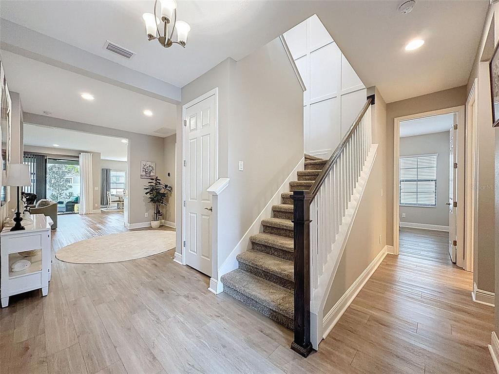 4312 Burdick Loop Odessa, FL 33556 - Photo 4 of 55 a view of a hallway with wooden floor and staircase