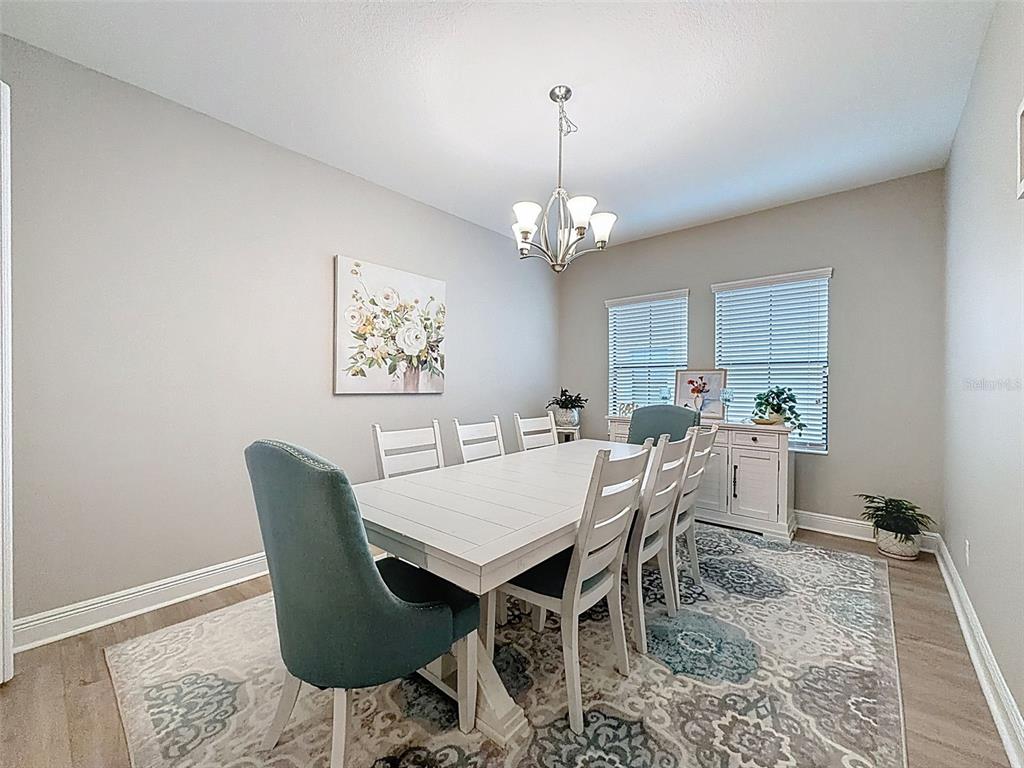 4312 Burdick Loop Odessa, FL 33556 - Photo 6 of 55 a view of a dining room with furniture and wooden floor