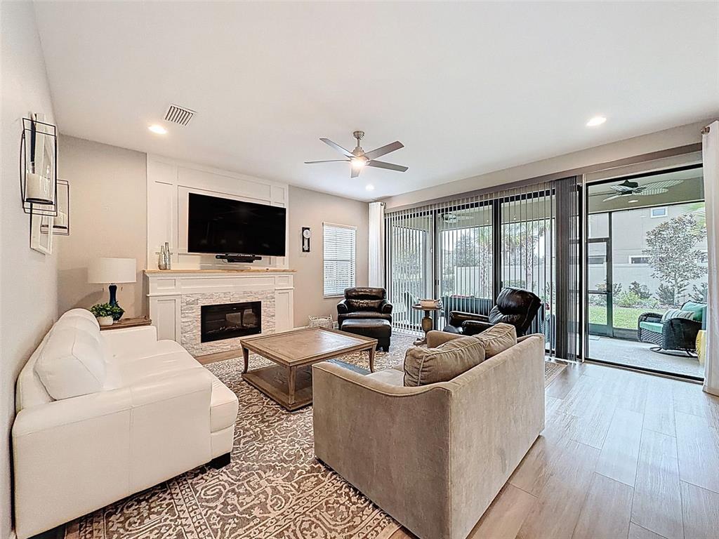 4312 Burdick Loop Odessa, FL 33556 - Photo 7 of 55 a living room with fireplace furniture and a flat screen tv