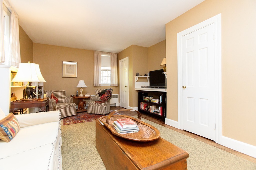 25 Longmeadow Road Wellesley, MA 02482 - Photo 16 of 24 a living room with furniture and a fireplace