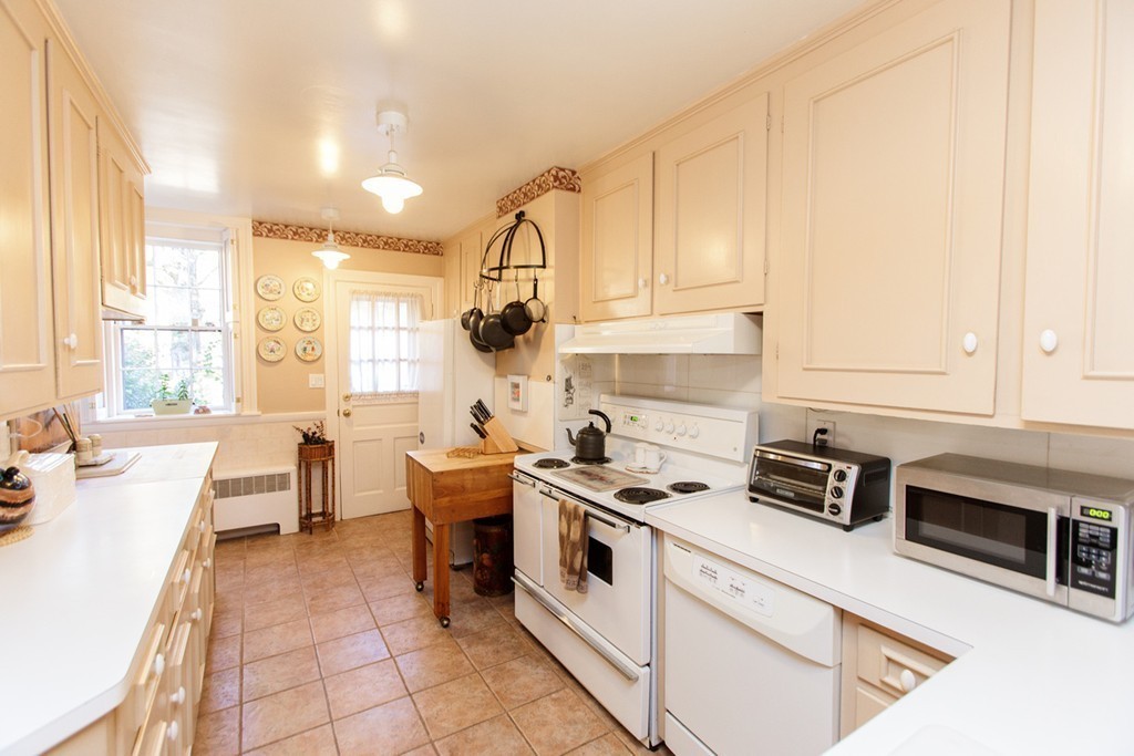 25 Longmeadow Road Wellesley, MA 02482 - Photo 9 of 24 a kitchen with a sink a stove and cabinets