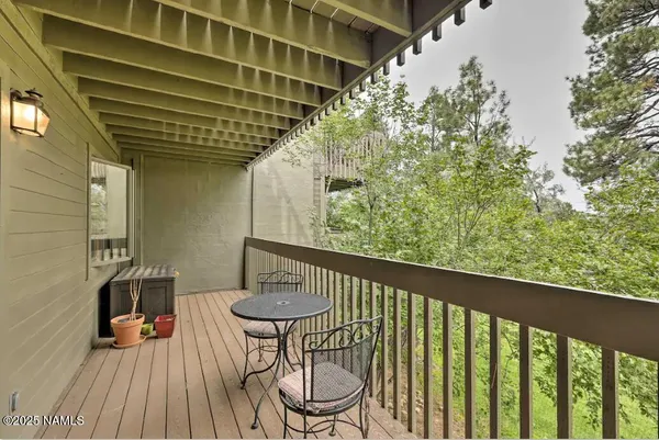 a balcony view with a seating space