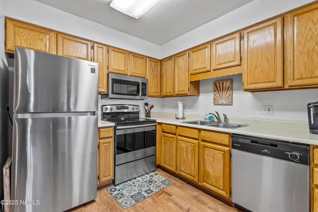 a kitchen with stainless steel appliances granite countertop a stove a sink dishwasher and a microwave