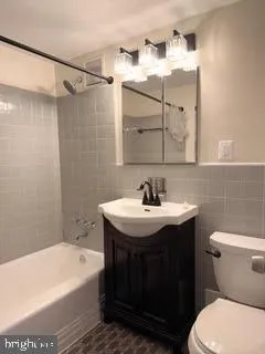 a bathroom with a sink a toilet and bathtub