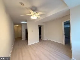 an empty room with fan and entrance