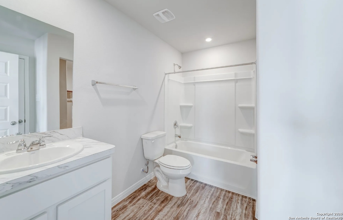 113 Sutton Place Uvalde, TX 78801 - Photo 4 of 6 a bathroom with a sink a toilet and a large mirror