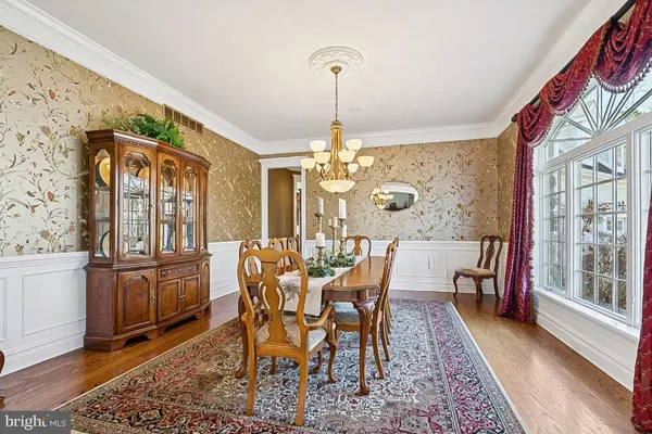 a large kitchen with a table and chairs in it