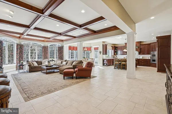 a kitchen with stainless steel appliances a stove a chimney a sink and cabinets