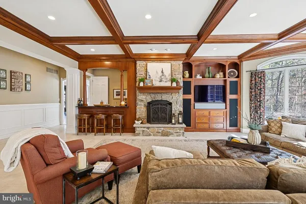 a dining room with furniture a chandelier and fireplace
