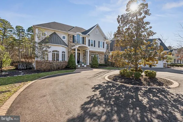 a view of a hallway with wooden floor and a living room