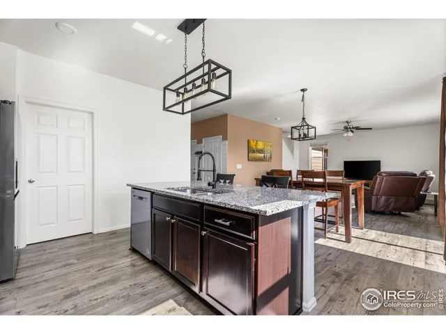 a kitchen with a sink a counter space and stainless steel appliances