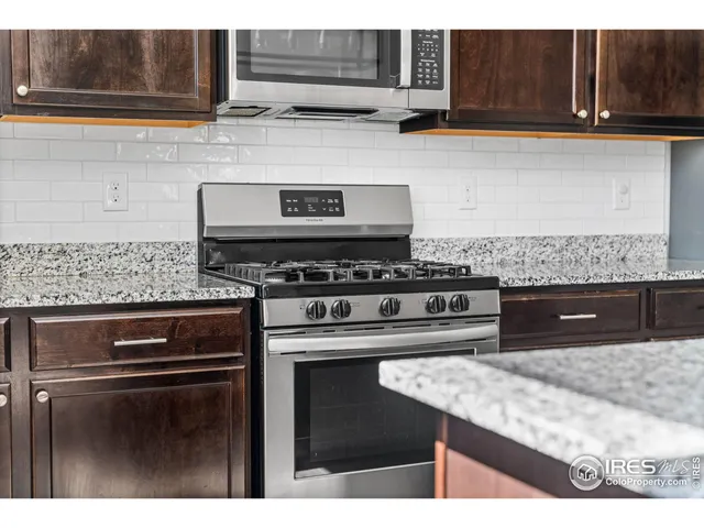 a kitchen with appliances cabinets and a counter top space