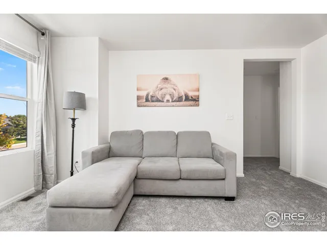 a living room with furniture and a painting