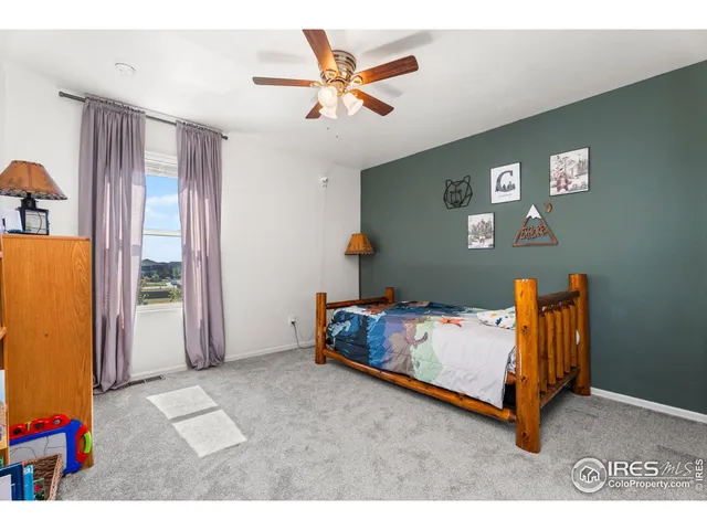 a bedroom with furniture and a large window