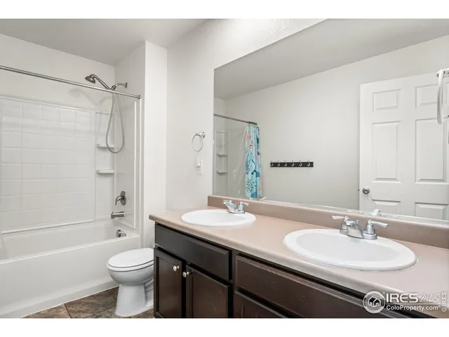a bathroom with a granite countertop sink toilet a shower and a mirror
