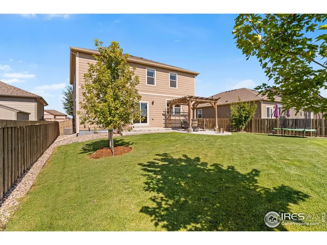a view of house with garden space and trees