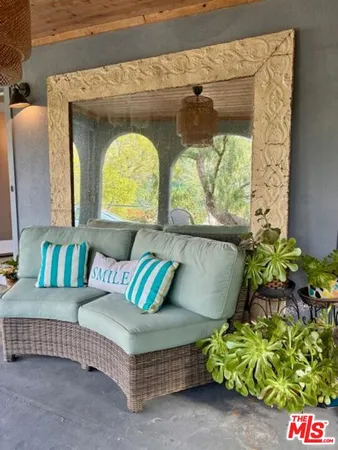 a living room with a couch and a potted plant