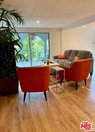 a living room with a couch and a potted plant