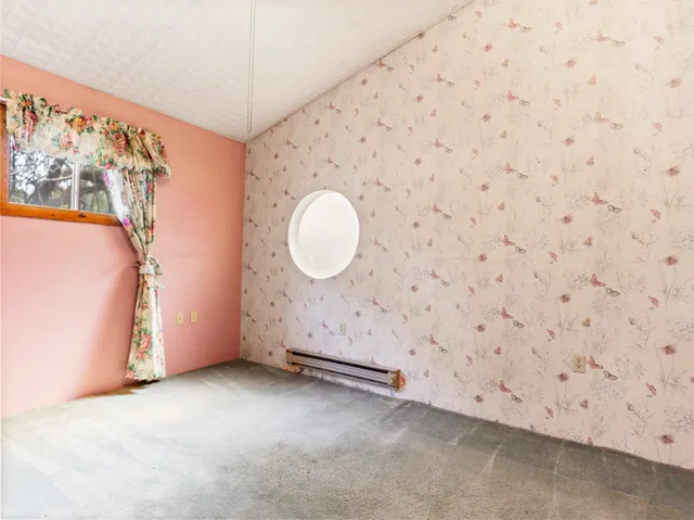 a view of a room with window and wooden floor