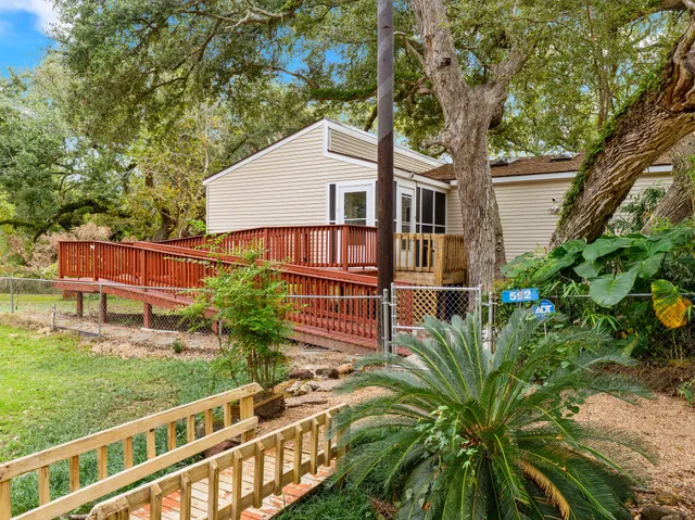 a view of a house with a yard and potted plants