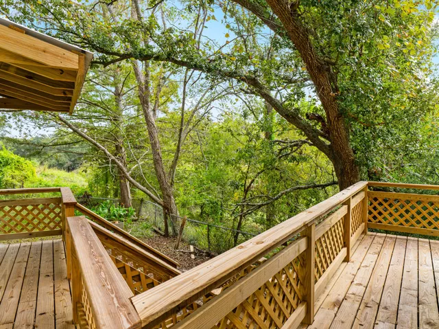 an aerial view of residential houses with outdoor space and trees