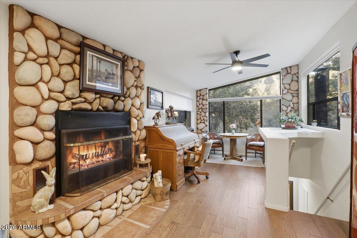 4426 North State Rte 89A, Unit 13 Sedona, AZ 86336 - Photo 14 of 47 a living room with furniture a fireplace and a floor to ceiling window