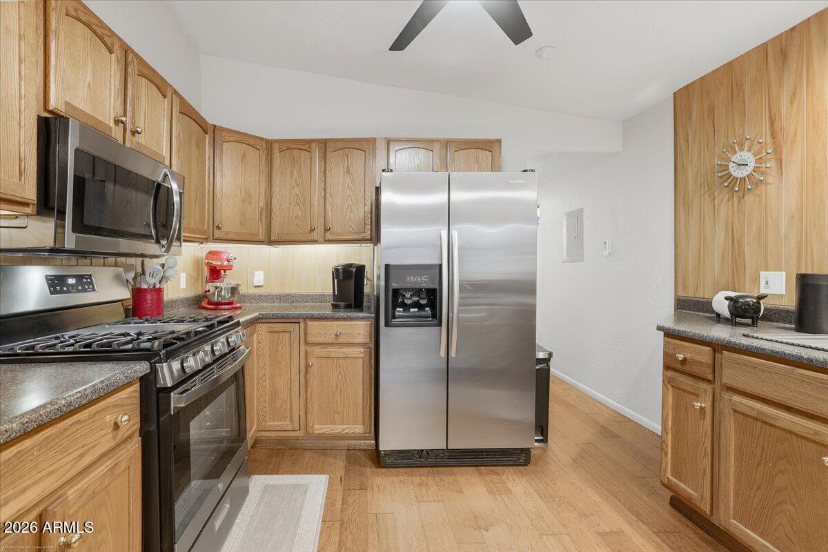 4426 North State Rte 89A, Unit 13 Sedona, AZ 86336 - Photo 18 of 47 a kitchen with stainless steel appliances granite countertop a refrigerator a stove and a sink