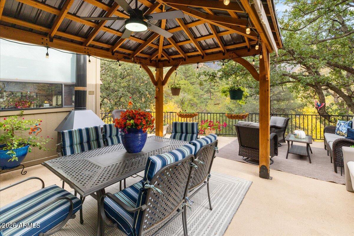 4426 North State Rte 89A, Unit 13 Sedona, AZ 86336 - Photo 32 of 47 a view of a patio with table and chairs potted plants with wooden floor and outdoor seating