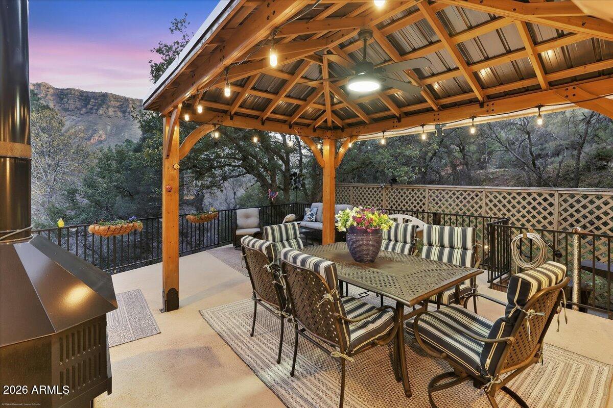 4426 North State Rte 89A, Unit 13 Sedona, AZ 86336 - Photo 34 of 47 a view of a patio with a table chairs and a backyard