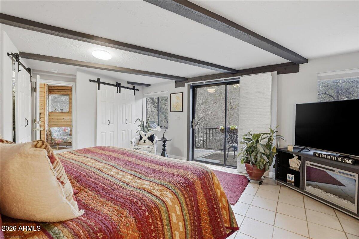 4426 North State Rte 89A, Unit 13 Sedona, AZ 86336 - Photo 41 of 47 a bedroom with a bed and a flat screen tv