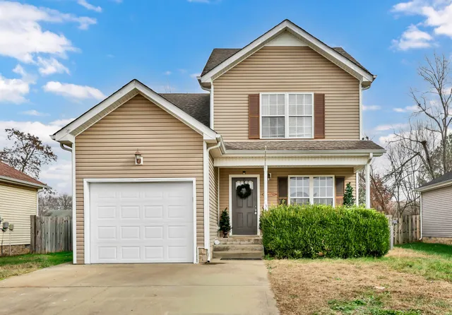 a view of a house with a yard and garage