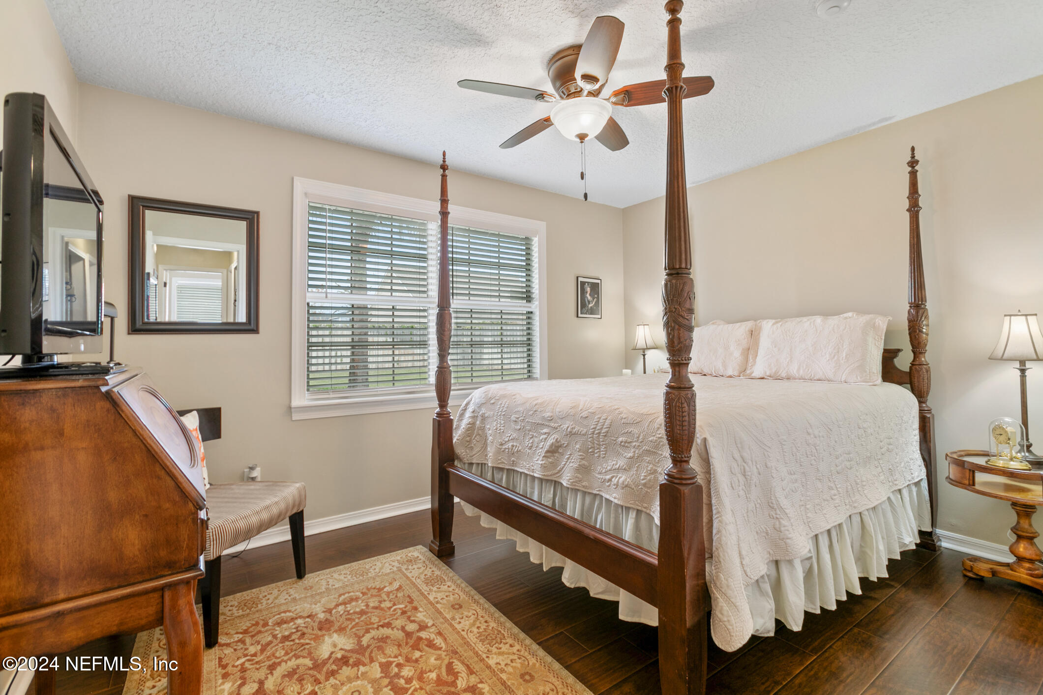 540 Moultrie Wells Road St. Augustine, FL 32086 - Photo 13 of 44 a bedroom with a bed a chandelier and the dresser