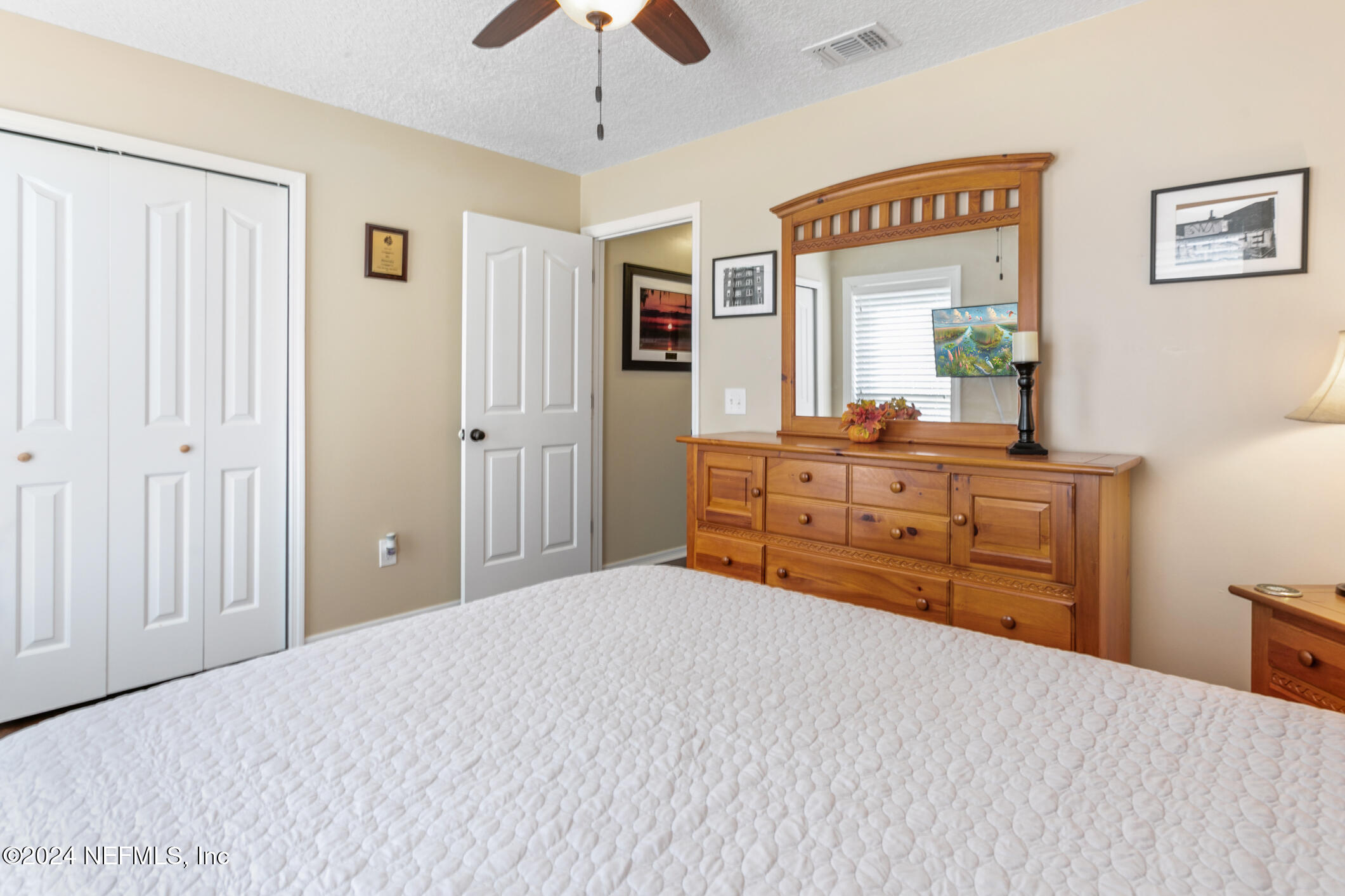 540 Moultrie Wells Road St. Augustine, FL 32086 - Photo 18 of 44 a bedroom with a bed and a dresser