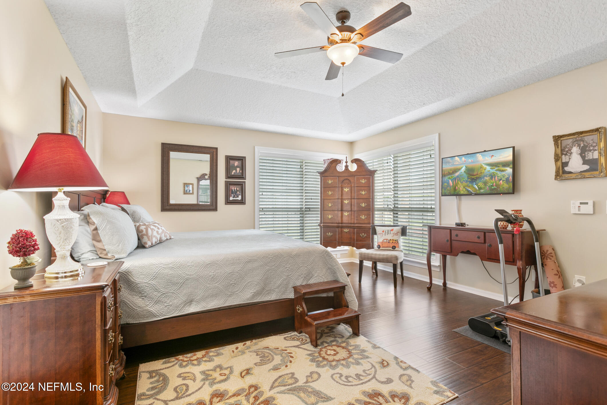 540 Moultrie Wells Road St. Augustine, FL 32086 - Photo 19 of 44 a bedroom with a bed and a chandelier