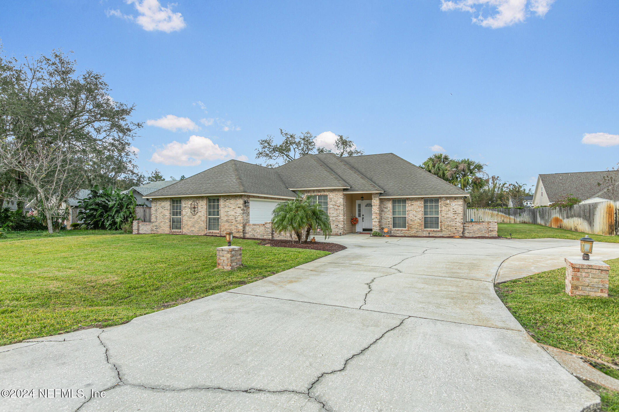 540 Moultrie Wells Road St. Augustine, FL 32086 - Photo 2 of 44 a front view of a house with a yard
