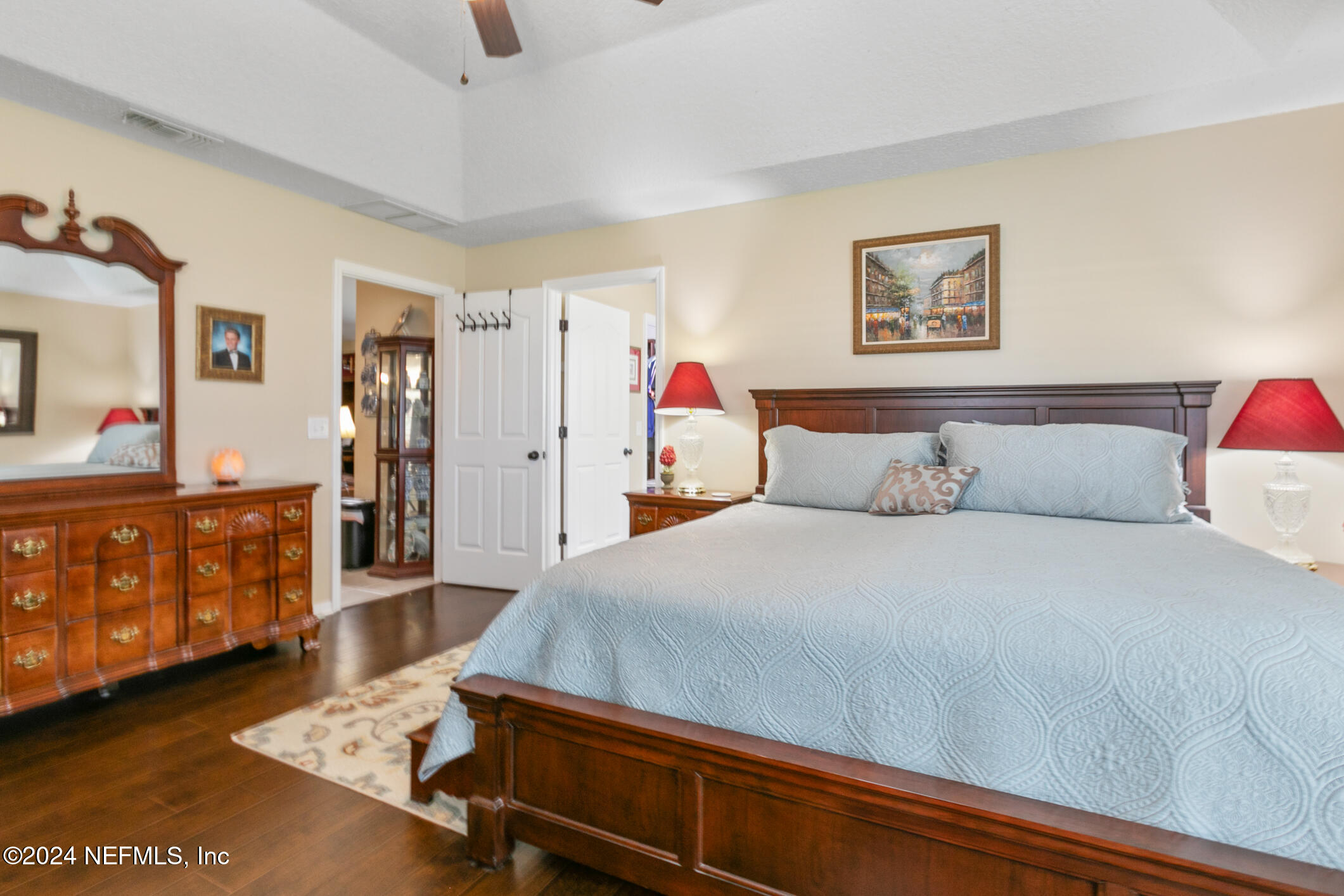 540 Moultrie Wells Road St. Augustine, FL 32086 - Photo 21 of 44 a bedroom with a bed and paintings on the wall