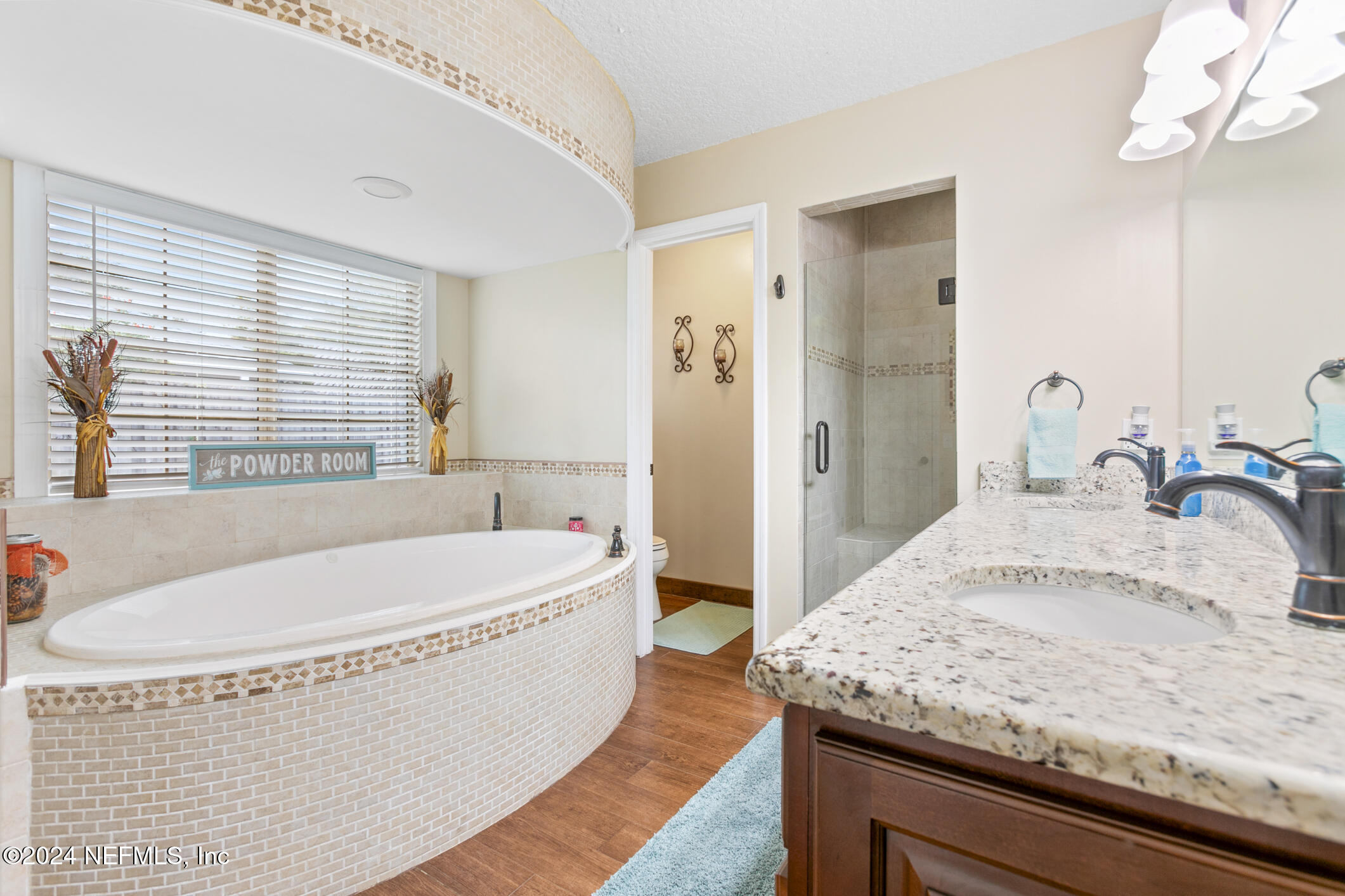 540 Moultrie Wells Road St. Augustine, FL 32086 - Photo 22 of 44 a spacious bathroom with a granite countertop tub and a sink