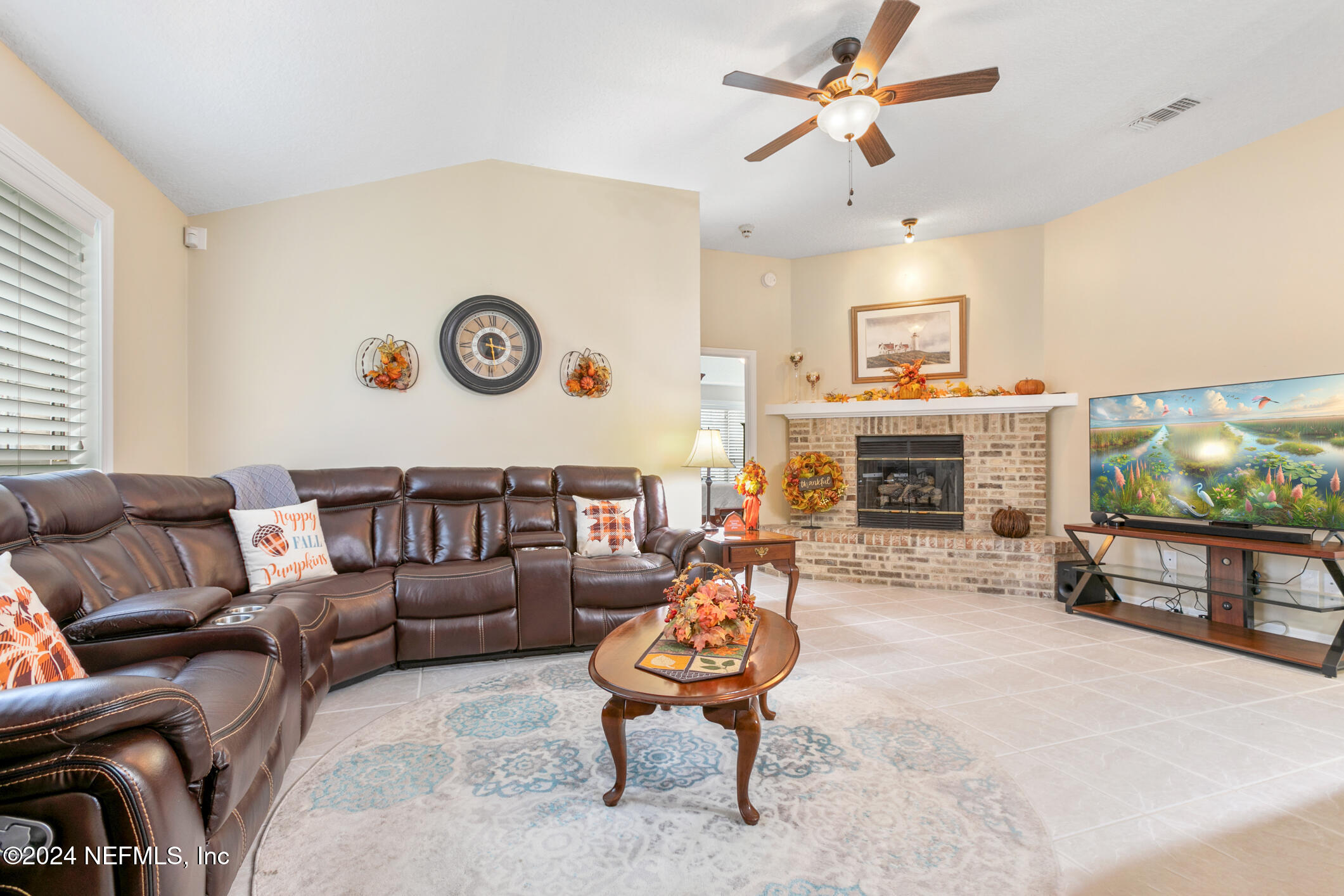 540 Moultrie Wells Road St. Augustine, FL 32086 - Photo 27 of 44 a living room with furniture a flat screen tv and a fireplace