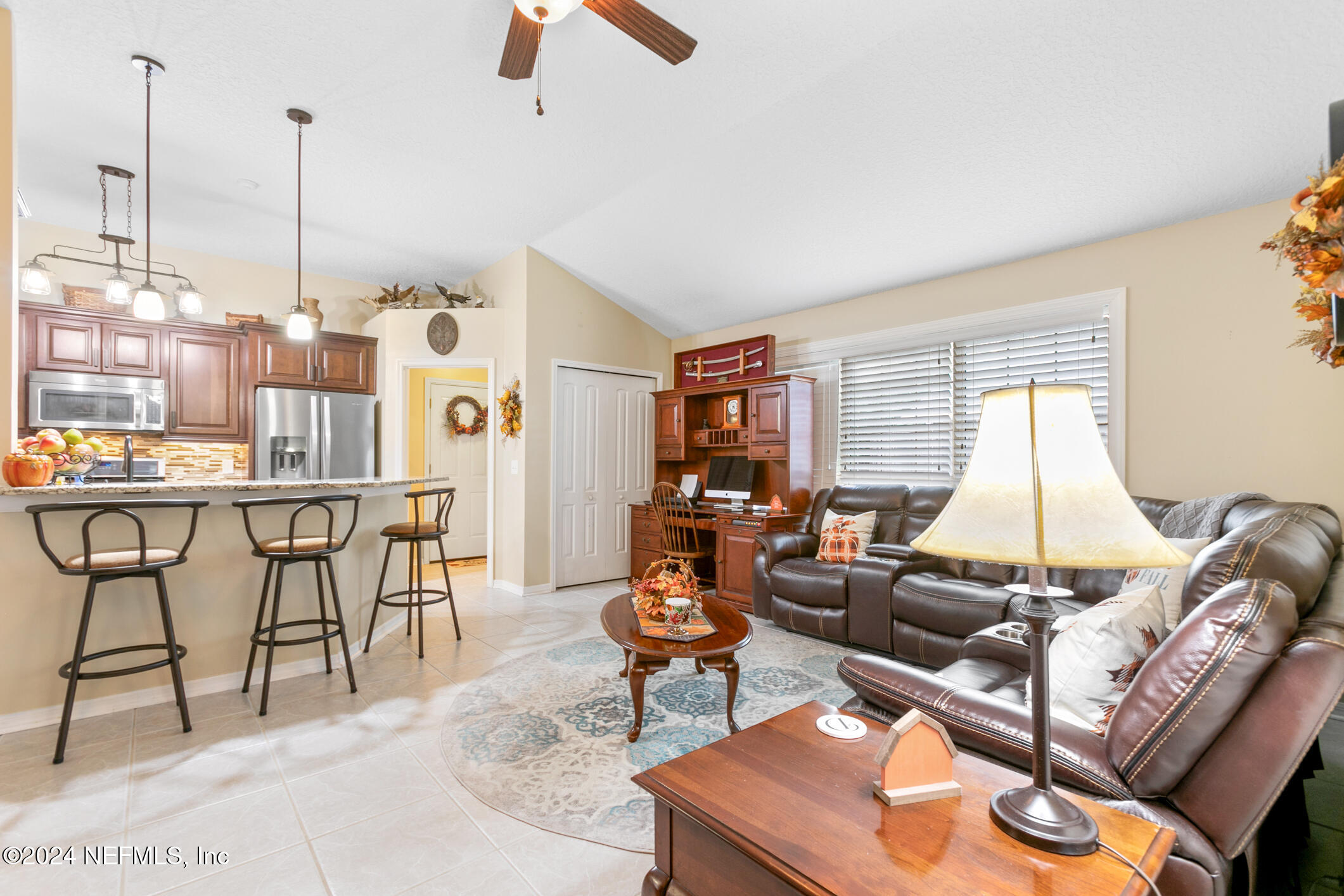 540 Moultrie Wells Road St. Augustine, FL 32086 - Photo 29 of 44 a living room with furniture a rug and a floor to ceiling window